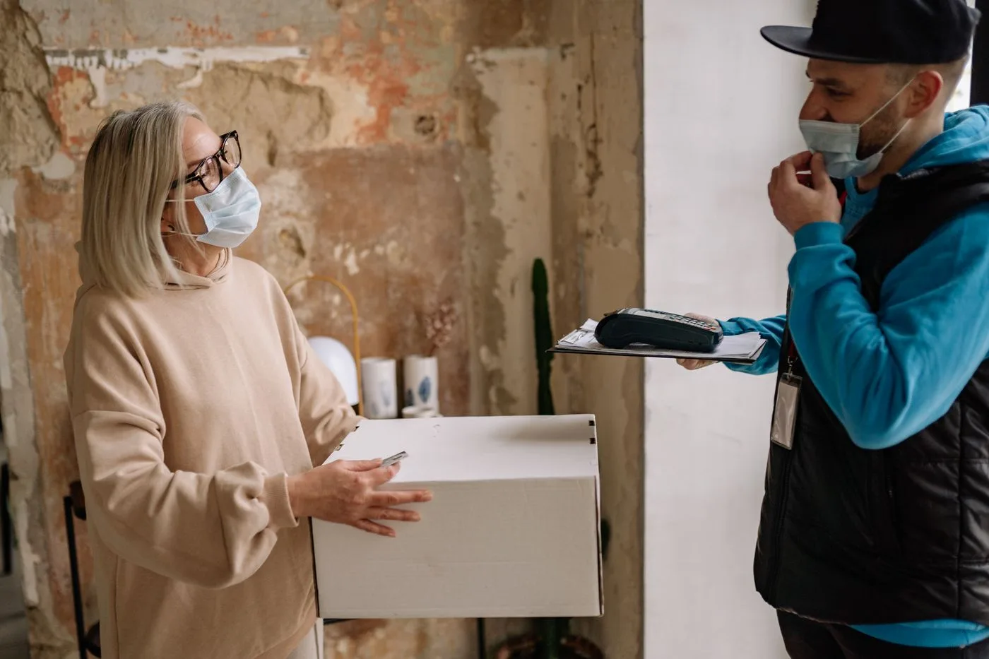 An older woman accepts a package at her home
