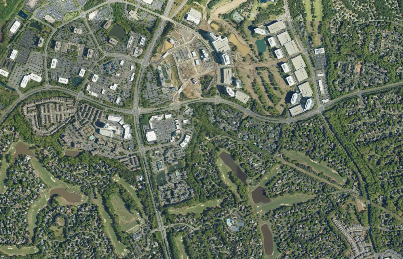 Aerial view of green neighborhoods and tree-lined roads in south Charlotte